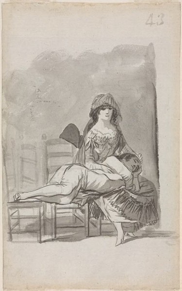 Maja sentada con un hombre echado sobre sus rodillas